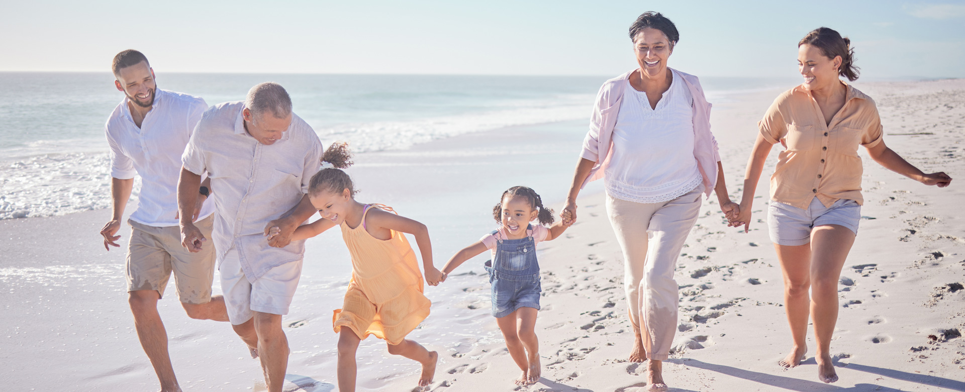 family on the beach holding hands